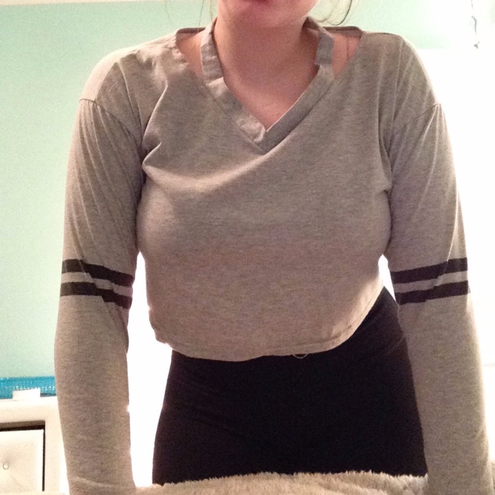 gray crop top with black strips on arms